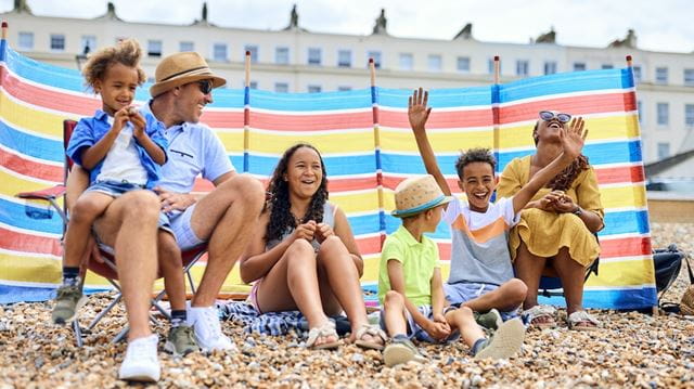 Family enjoying time on the beach in the UK